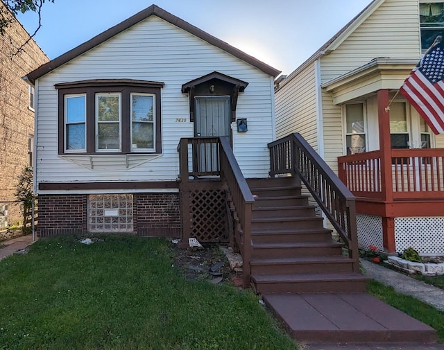 bungalow-style house with a front lawn