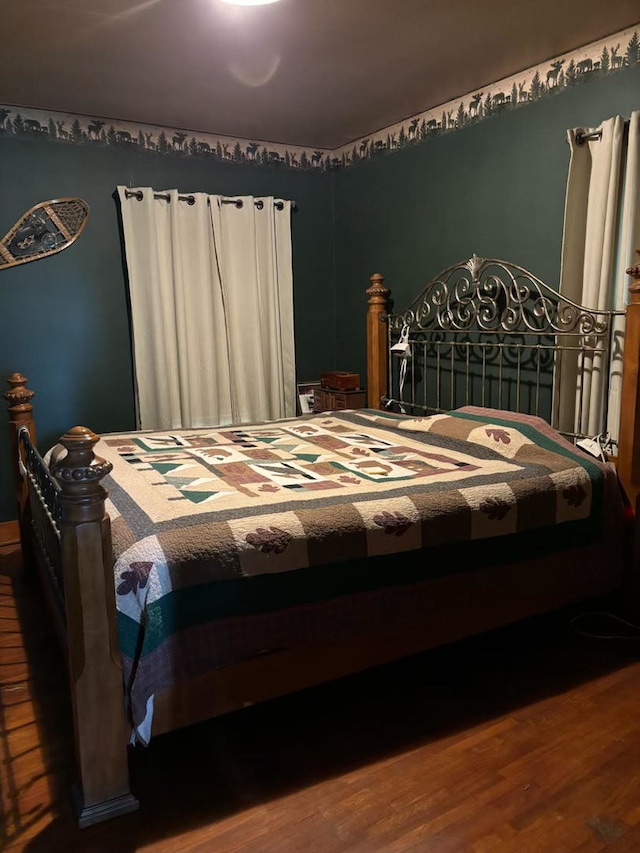 bedroom with hardwood / wood-style floors