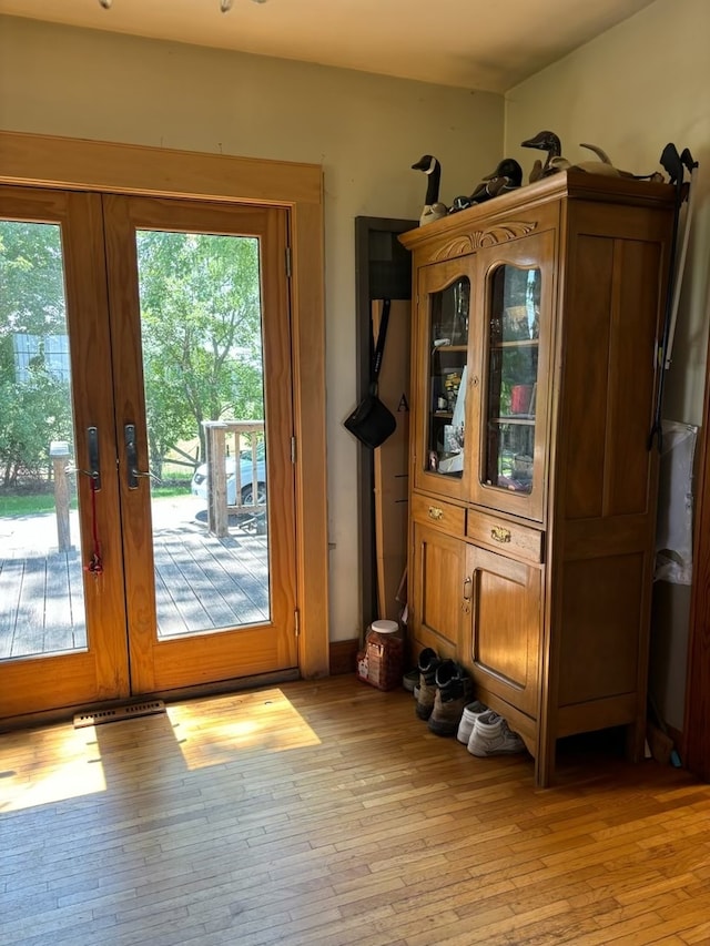 entryway featuring plenty of natural light, light hardwood / wood-style flooring, and french doors