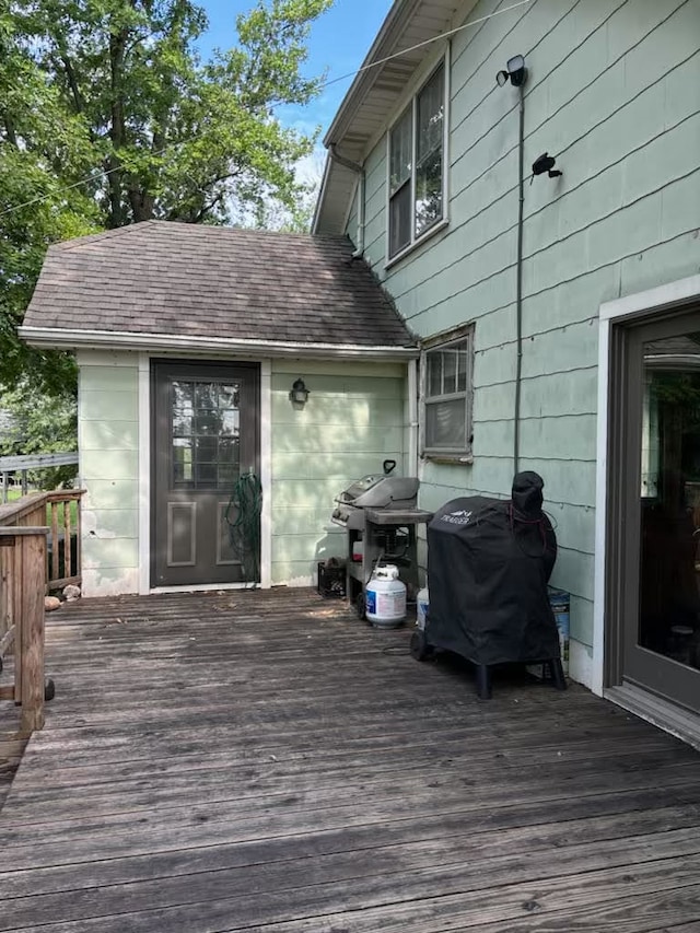 wooden deck featuring a grill