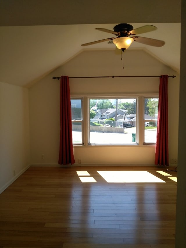 bonus room featuring hardwood / wood-style floors, ceiling fan, and lofted ceiling