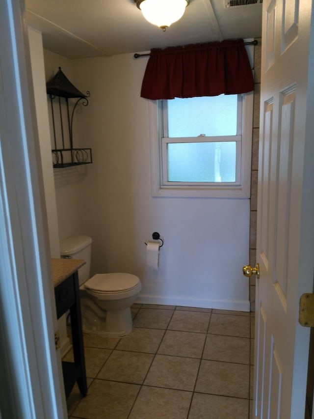 bathroom featuring tile patterned floors, vanity, and toilet