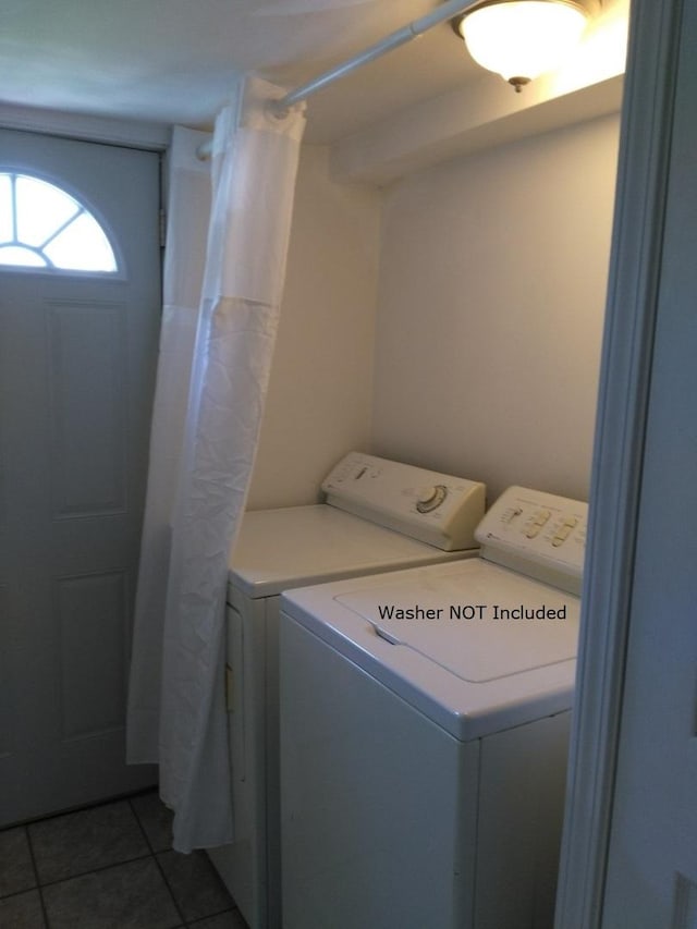 laundry room featuring independent washer and dryer and dark tile patterned floors