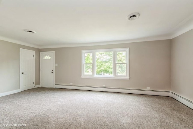 unfurnished room with crown molding, carpet, and a baseboard radiator