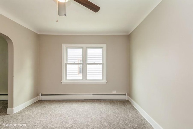 carpeted spare room with baseboard heating and ceiling fan