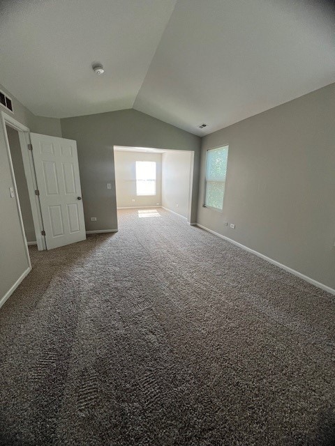 additional living space with carpet flooring and vaulted ceiling