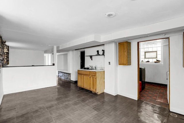 unfurnished living room featuring sink