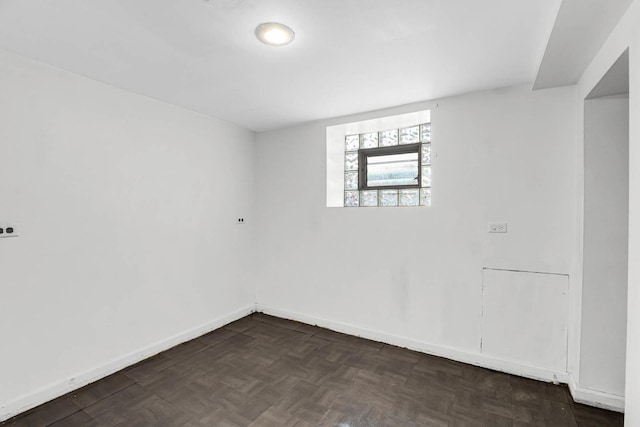 spare room with dark parquet flooring