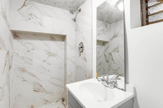 bathroom featuring vanity and tiled shower