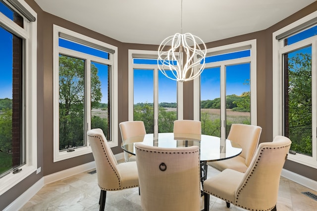 dining space featuring a notable chandelier and light tile patterned floors