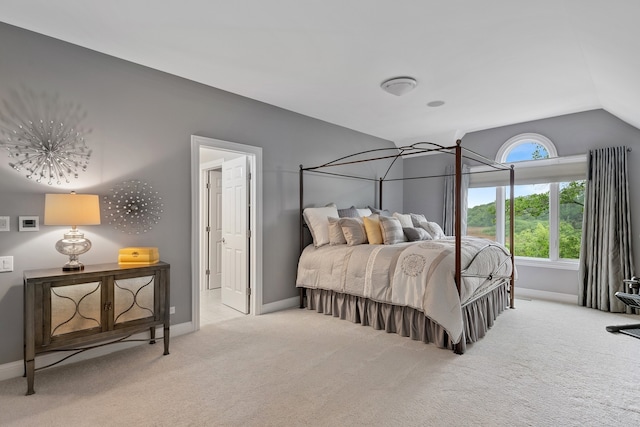 bedroom with light carpet and vaulted ceiling