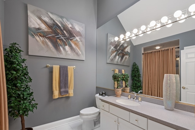 bathroom with vanity, tile patterned flooring, and toilet