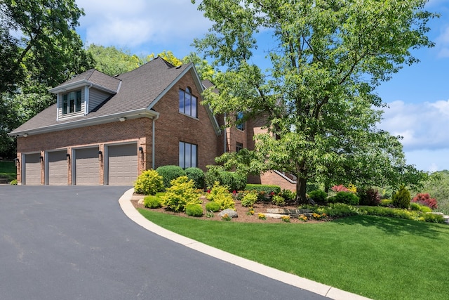 view of front of property featuring a garage and a front yard