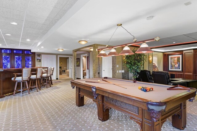 game room with indoor bar, billiards, light tile patterned floors, and a paneled ceiling