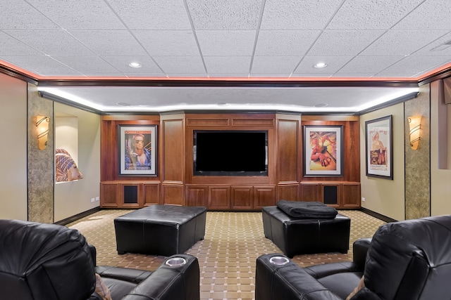 carpeted home theater room with ornamental molding