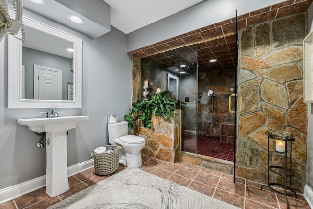 bathroom featuring a shower with shower door, tile patterned floors, and toilet