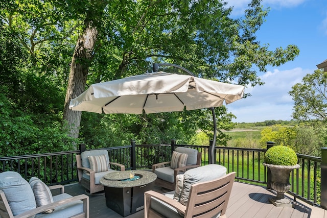 wooden terrace featuring an outdoor fire pit