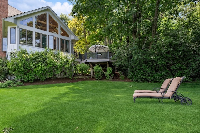 view of yard featuring a wooden deck and a sunroom