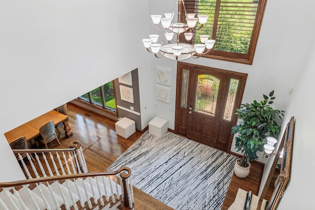 entrance foyer featuring an inviting chandelier and wood-type flooring