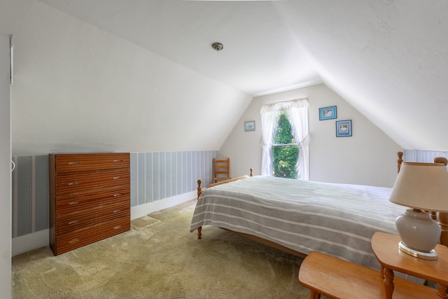 carpeted bedroom featuring lofted ceiling