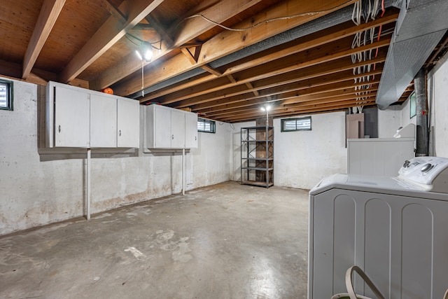 basement with a wealth of natural light and washing machine and dryer