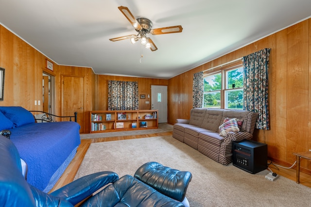 living room featuring wood walls and ceiling fan