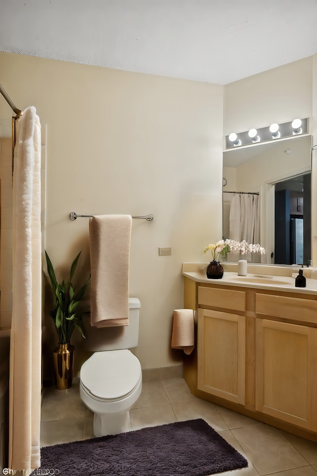 bathroom featuring tile patterned flooring, vanity, a shower with shower curtain, and toilet