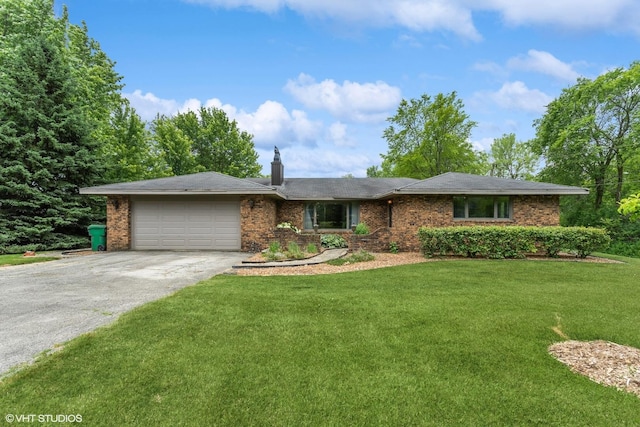 ranch-style home featuring a garage, aphalt driveway, a front yard, and brick siding