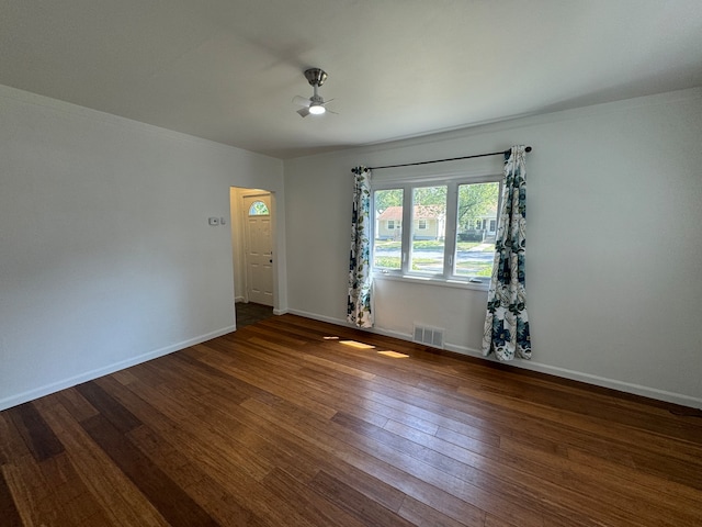 empty room with dark hardwood / wood-style flooring and ceiling fan