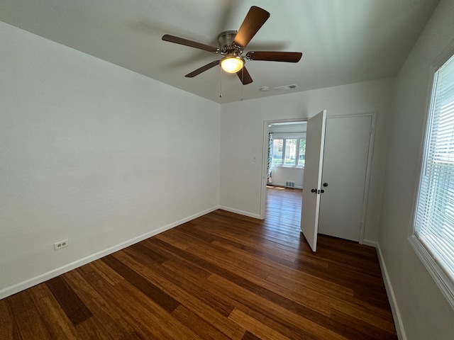 unfurnished room featuring ceiling fan and dark hardwood / wood-style floors