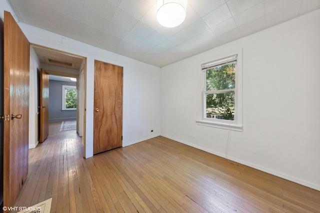 empty room with light hardwood / wood-style floors