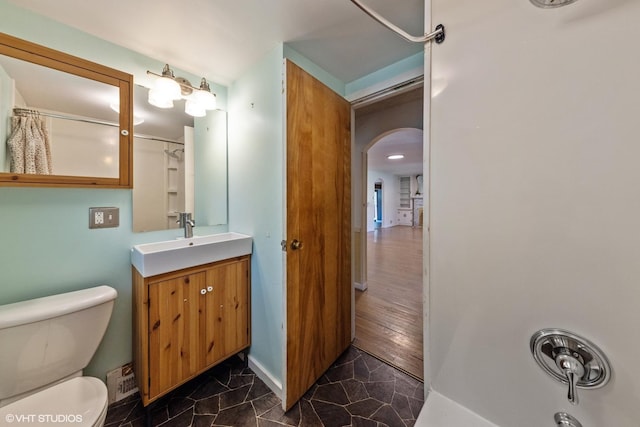 bathroom featuring toilet and vanity