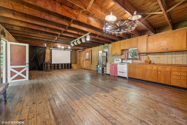 interior space featuring stainless steel refrigerator, track lighting, dark hardwood / wood-style floors, and wood ceiling