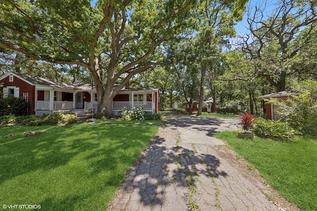 ranch-style house with a front yard and a porch