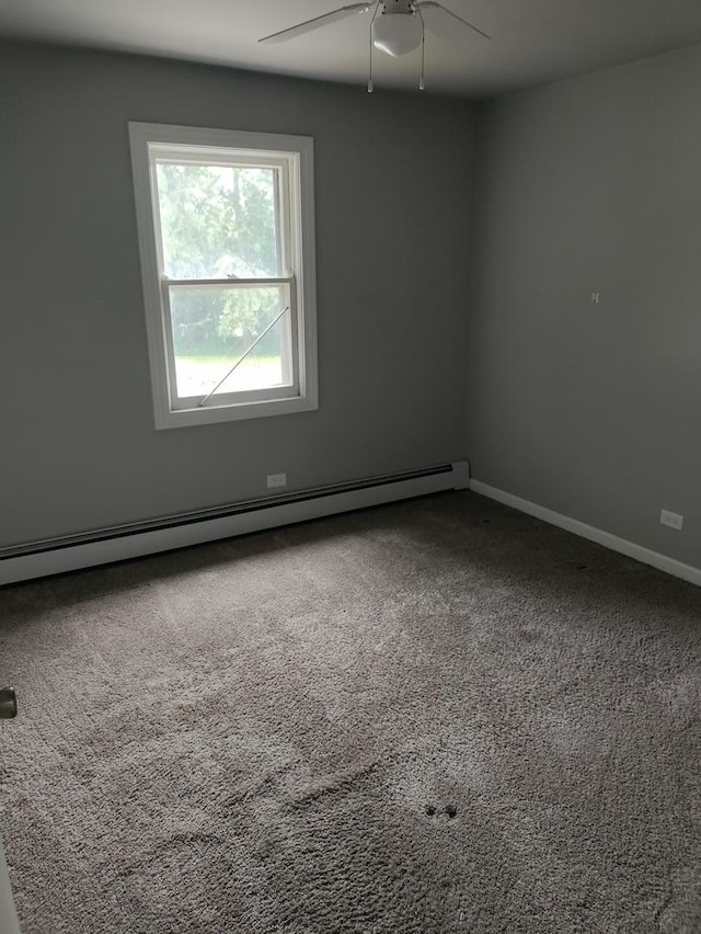 carpeted empty room with a baseboard heating unit and ceiling fan