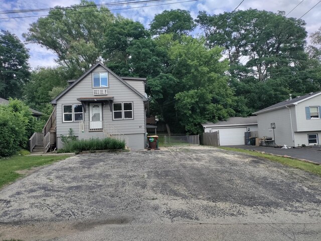 view of front of house featuring a garage and an outdoor structure