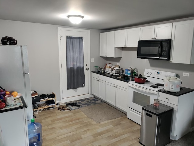 kitchen featuring white appliances, white cabinets, and light wood-type flooring