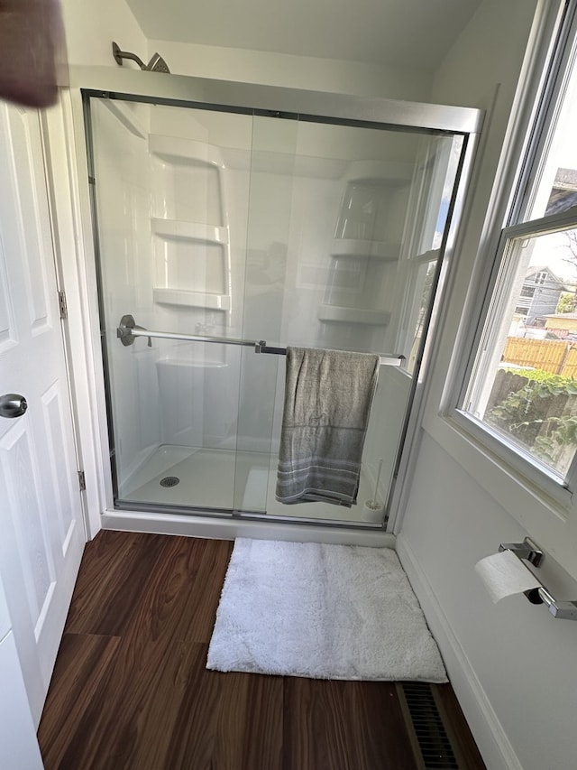 bathroom featuring hardwood / wood-style floors and walk in shower