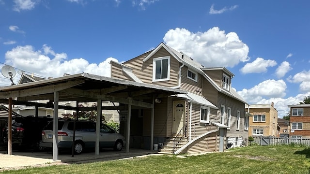 exterior space featuring a yard and a carport