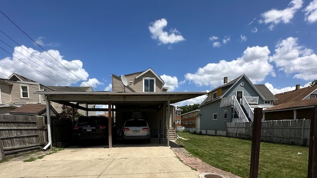 view of parking with a lawn and a carport