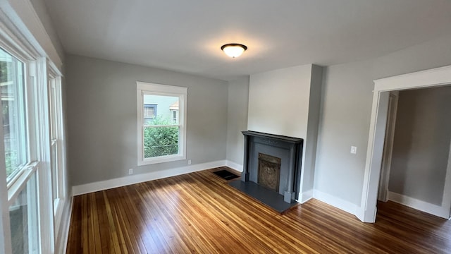 unfurnished living room featuring dark hardwood / wood-style flooring