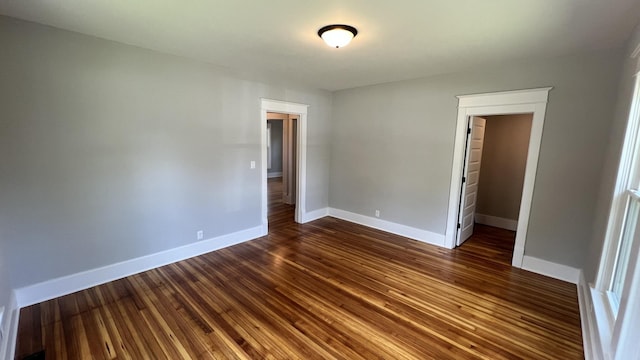 unfurnished bedroom featuring dark hardwood / wood-style floors