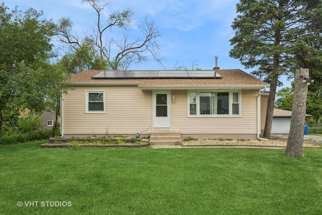 ranch-style house featuring solar panels and a front lawn