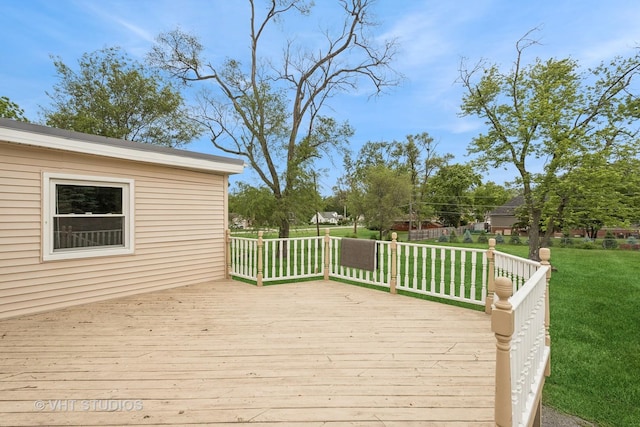 wooden deck featuring a yard