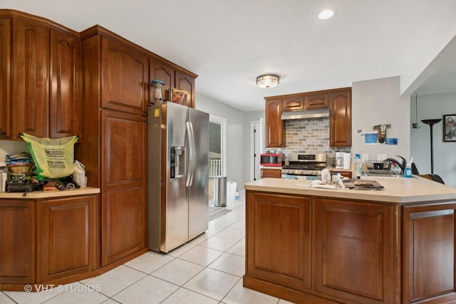 kitchen featuring light tile patterned flooring, stainless steel appliances, and tasteful backsplash