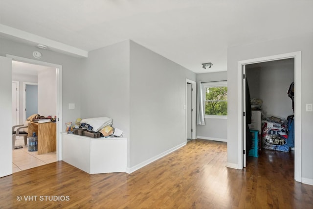 corridor with wood-type flooring