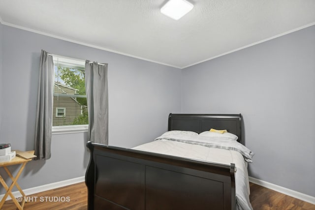 bedroom featuring ornamental molding and dark hardwood / wood-style flooring