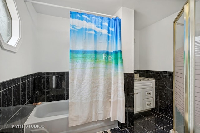 bathroom with shower / tub combo with curtain, tile walls, and vanity