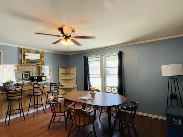 dining room featuring ceiling fan, crown molding, and wood-type flooring