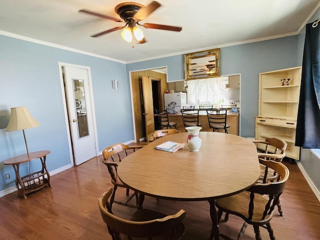 dining space with ornamental molding, dark hardwood / wood-style flooring, and ceiling fan